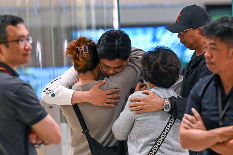 Alcuni passeggeri del volo Singapore Airlines confortati al loro arrivo - Afp