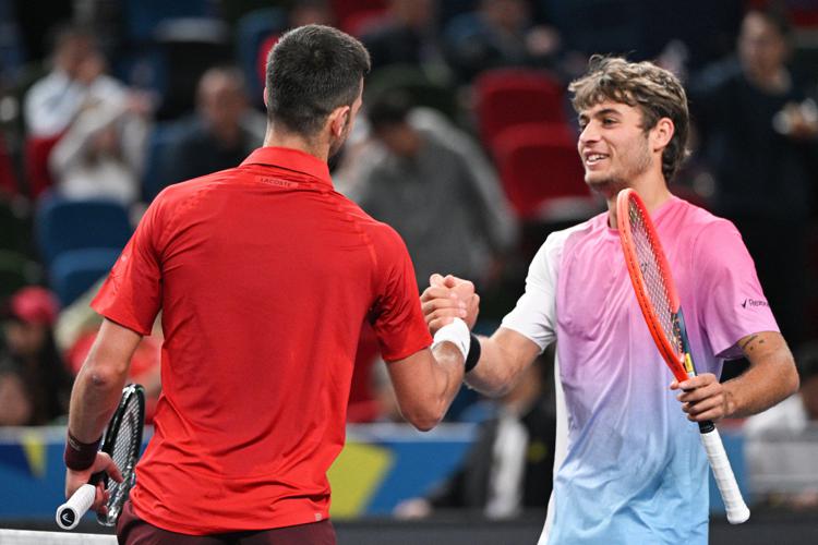 Novak Djokovic e Flavio Cobolli (Afp)