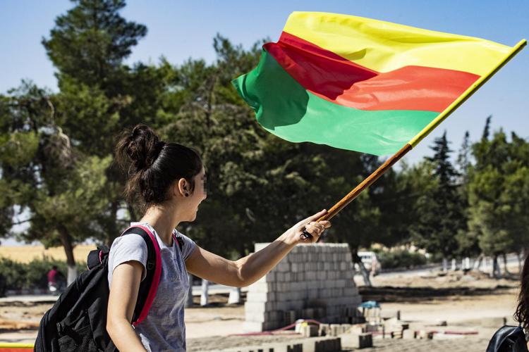 A young girl waves the flag of Kurdistan during a demonstration by Syrian Kurds against Turkish threats to launch a military operation on their region, in the town of Al-Qahtaniyah, in northeastern Syrian Al-Hasakah Governorate on October 7, 2019. - Turkish President Recep Tayyip Erdogan said today that his army was ready to launch operations against Kurdish militants in Syria at any moment following the US announcement that it would not stand in the way. (Photo by Delil SOULEIMAN / AFP) - AFP